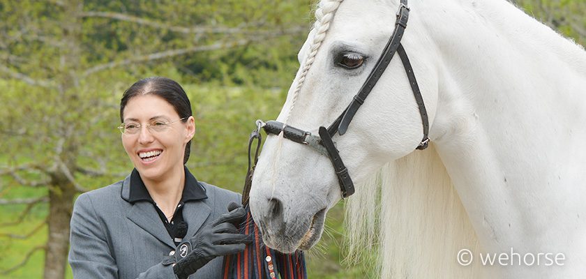 Classical dressage trainer Anja Beran with a grey horse.