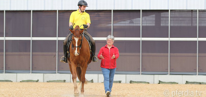 Riding instructor Sibylle Wiemer helps a student during a riding lesson.