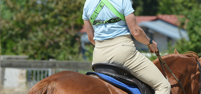 Riding with a Theraband wrapped around your stomach and back also helps you to feel and understand your breath.
