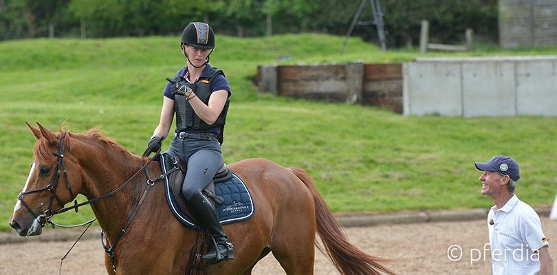 A cross country rider and her coach talking about the ride.