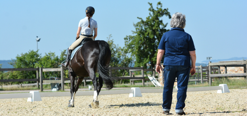 Riding instructor Sibylle Wiemer giving a lesson to a student.